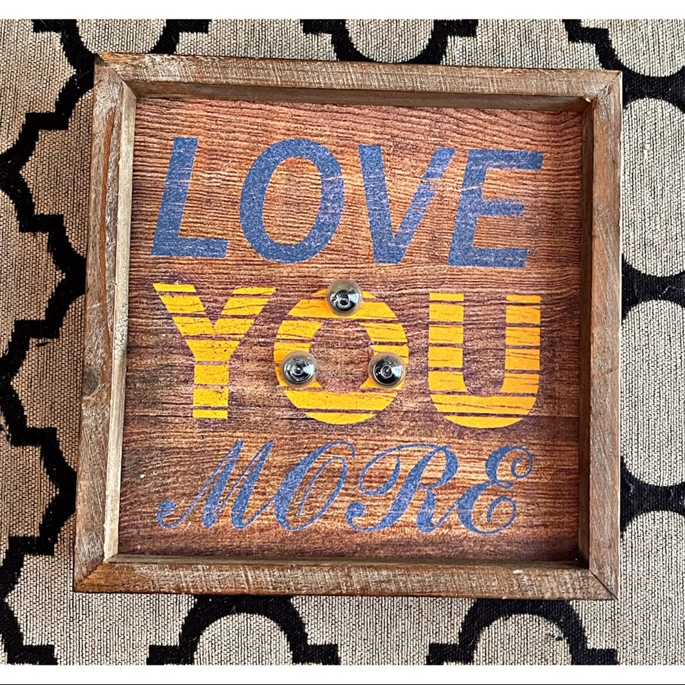 ‘Love You More’ sign decor with lights